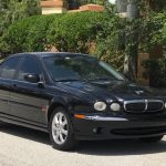 Black Jaguar parked in street